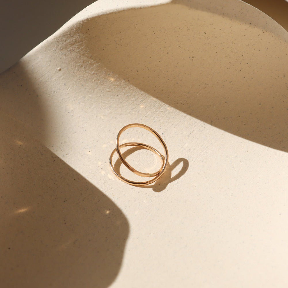 14k gold fill infinity ring laid on dish in the sunlight