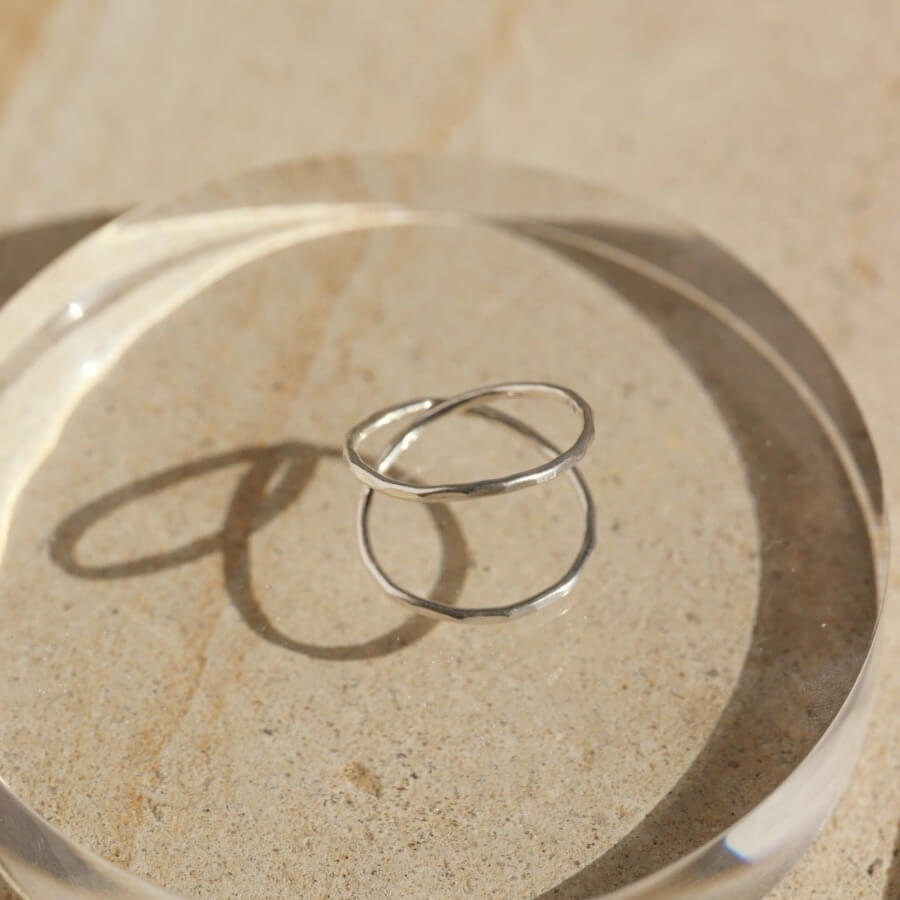 sterling silver infinity style hammered ring on a light dish
