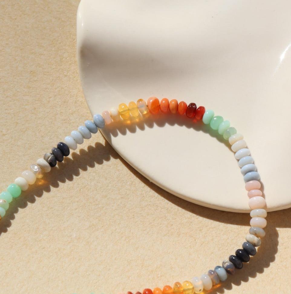 Kaleidoscope Bracelet on a white and tan plate in the sunlight