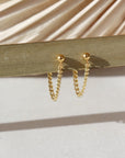14k gold fill small curb chain stud earrings hanging in the sunlight