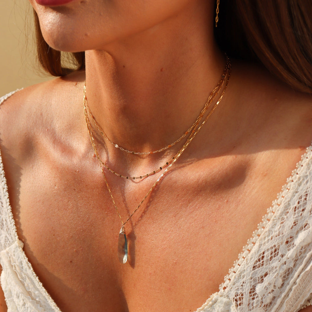 Laguna Pendant Necklace with faceted teardrop blue-green fluorite on petite gold fill box chain, styled layered with other sparkly chains