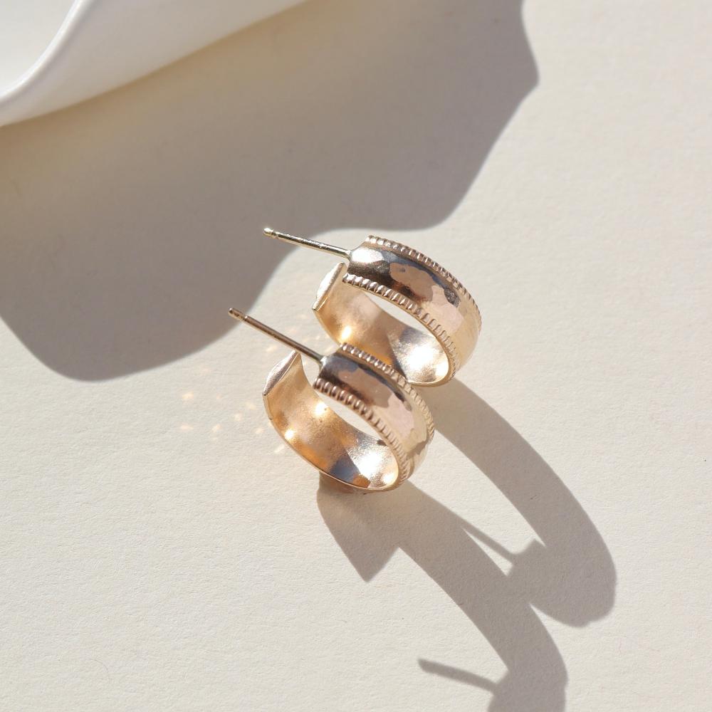 14k gold fill hammered textured stud hoop earrings on a light background