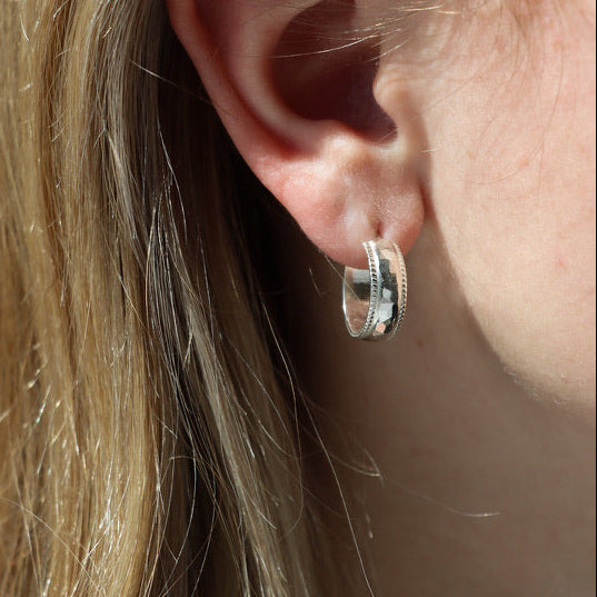 model wearing hammered textured stud hoop earrings 