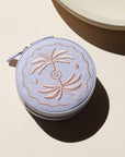 lavender circle travel jewelry case on a light background