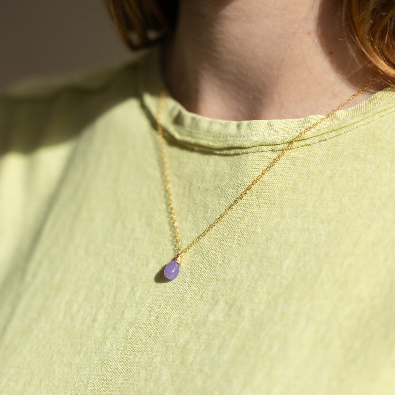 model wearing 14k gold fill delicate chain necklace with teardrop heckmanite gemstone