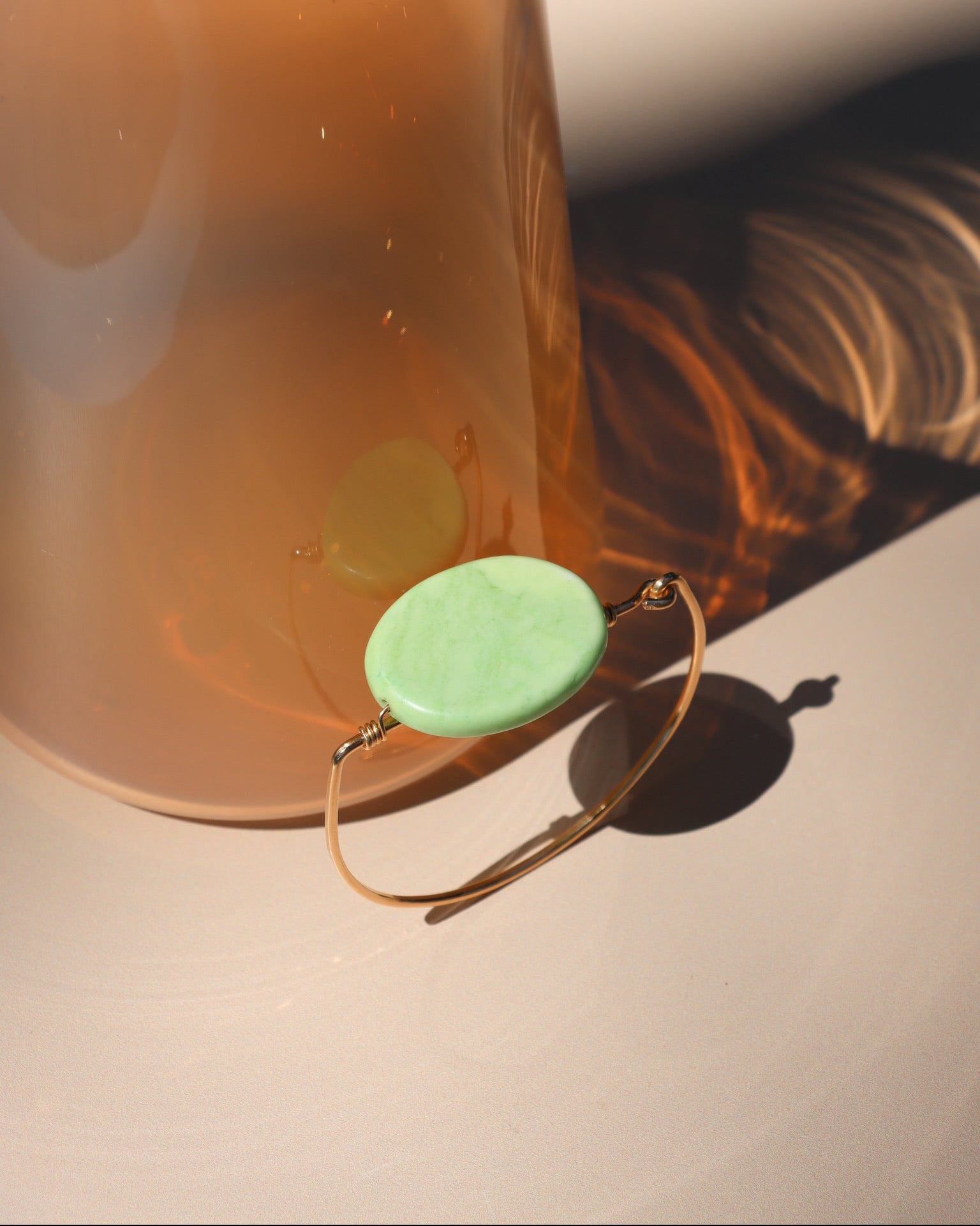 14k gold fill wire bracelet with oval chrysoprase stone in the sunlight