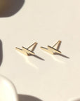 small 14k gold fill lightning bolt stud earrings, on a sunlit ceramic dish