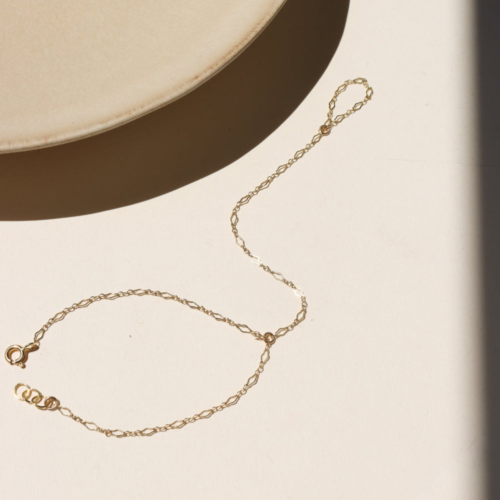 14k gold fill hand chain on a light background