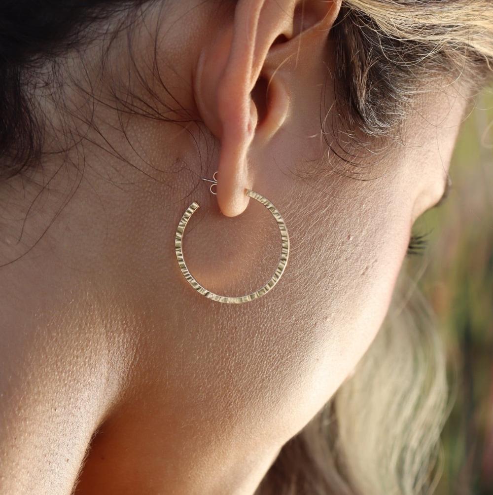 model wearing 14k gold fill textured hoops with 