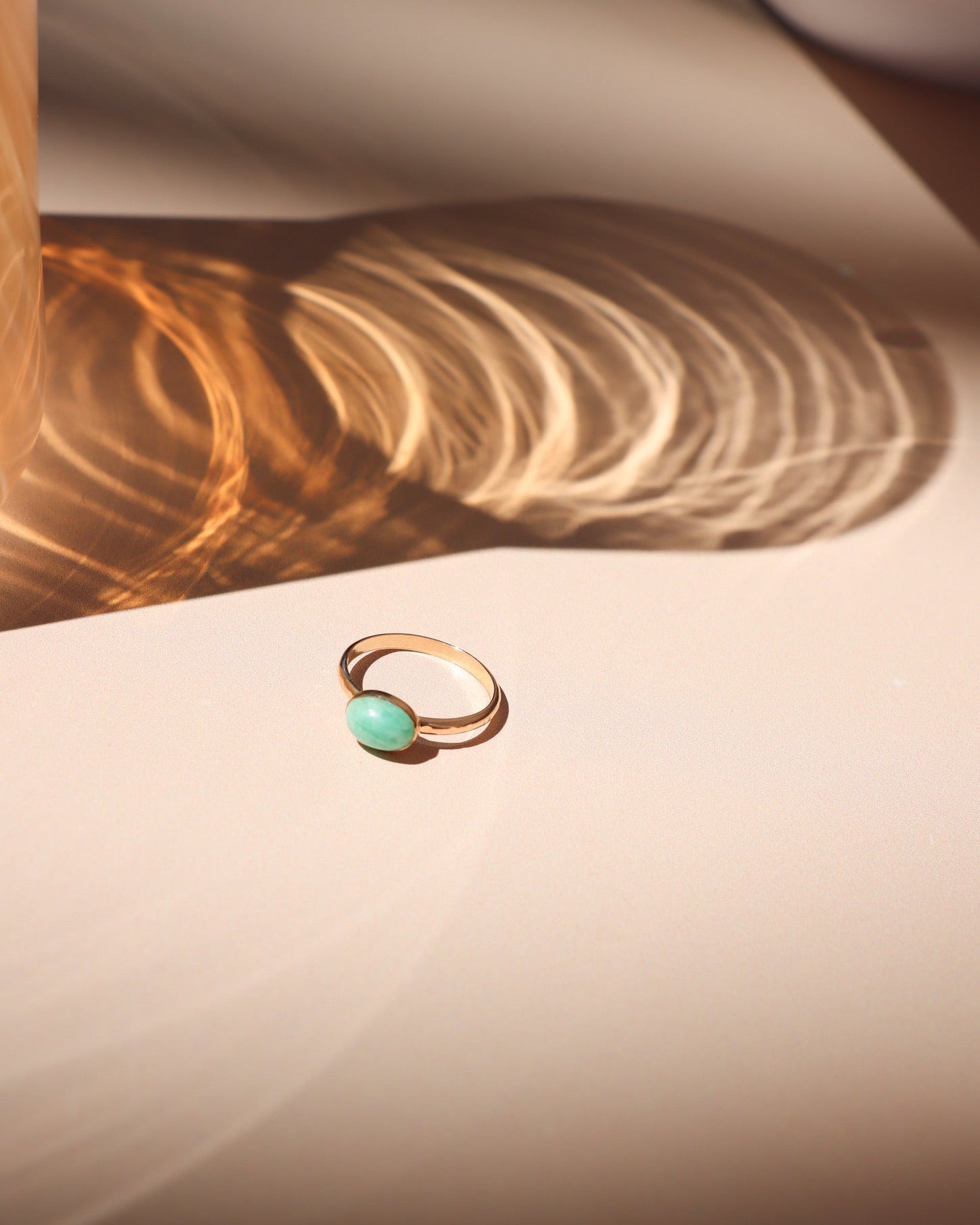 14k gold fill ring with oval amazonite stone on a light surface