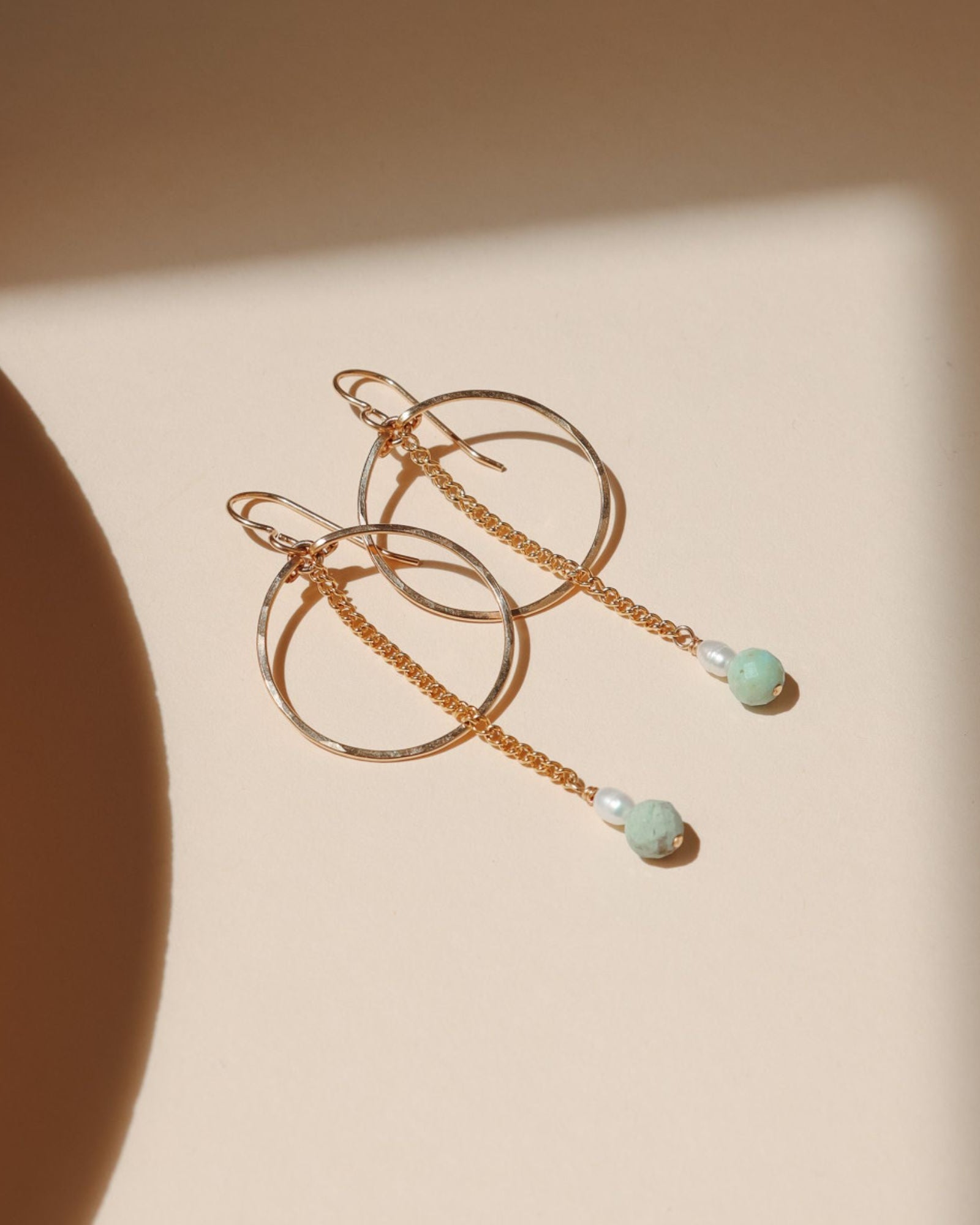 14k gold fill hoops with chain, pearl, and turquoise beads in the sunlight