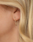model wearing 14k gold fill chain stud earrings with 14k gold fill hand chain 