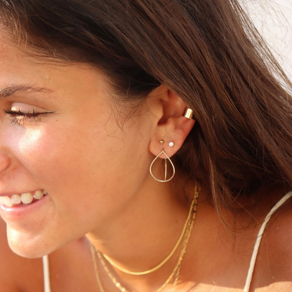 model wearing 14k gold fill earrings and ear cuff