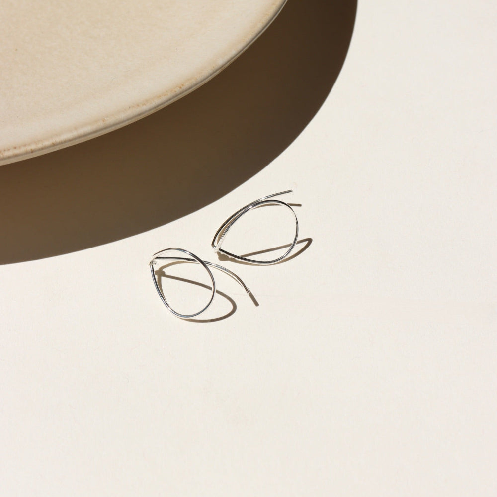 sterling silver teardrop earrings on a light background