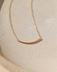 14k gold fill dainty chain with 14k gold fill tube on a light dish
