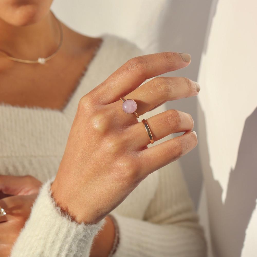 Model wearing our gold Pippa ring. This ring features a Pink Kunzite gemstone with a delicate spiral band. 