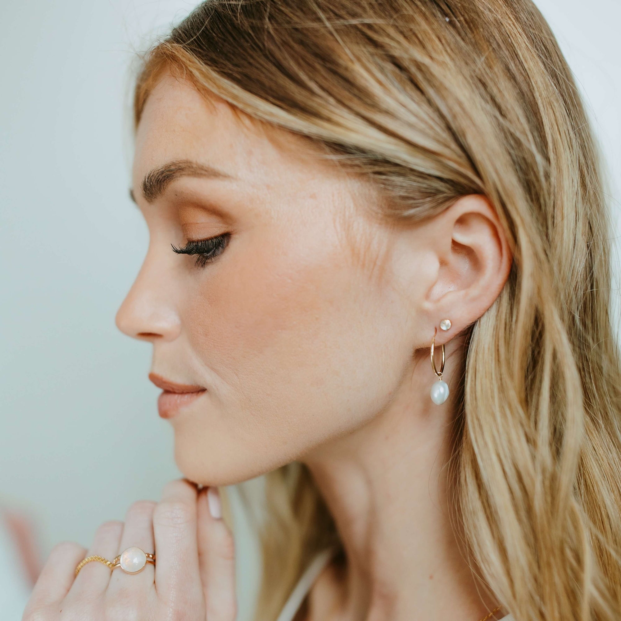 Model wearing 14k gold fill Moonstone Studs - Token Jewelry - eau claire jewelry store - jewelry store near me - 14k gold fill jewelry - sterling silver jewelry - gemstone earrings - womens jewelry style - minimalist style jewelry