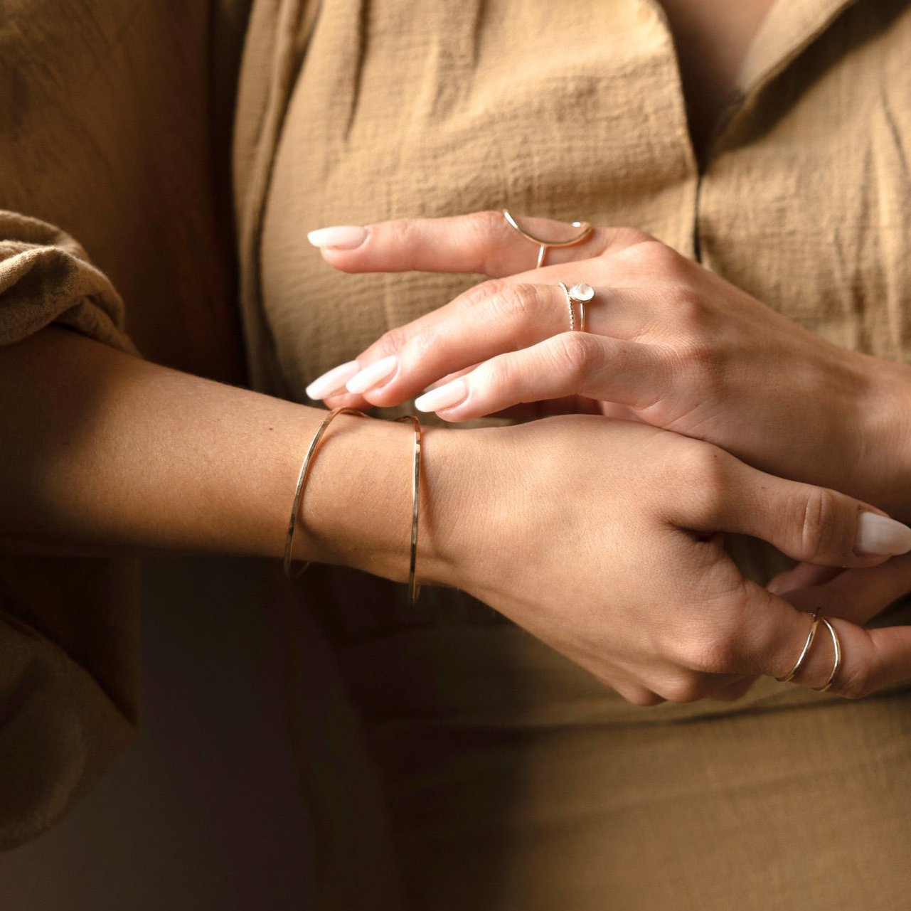Model wearing 14k gold fill Sundari cuff and other 14k gold fill rings from token jewelry