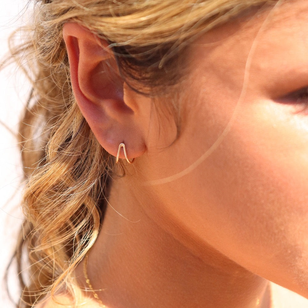 Model wearing 14k gold fill Wishbone Studs