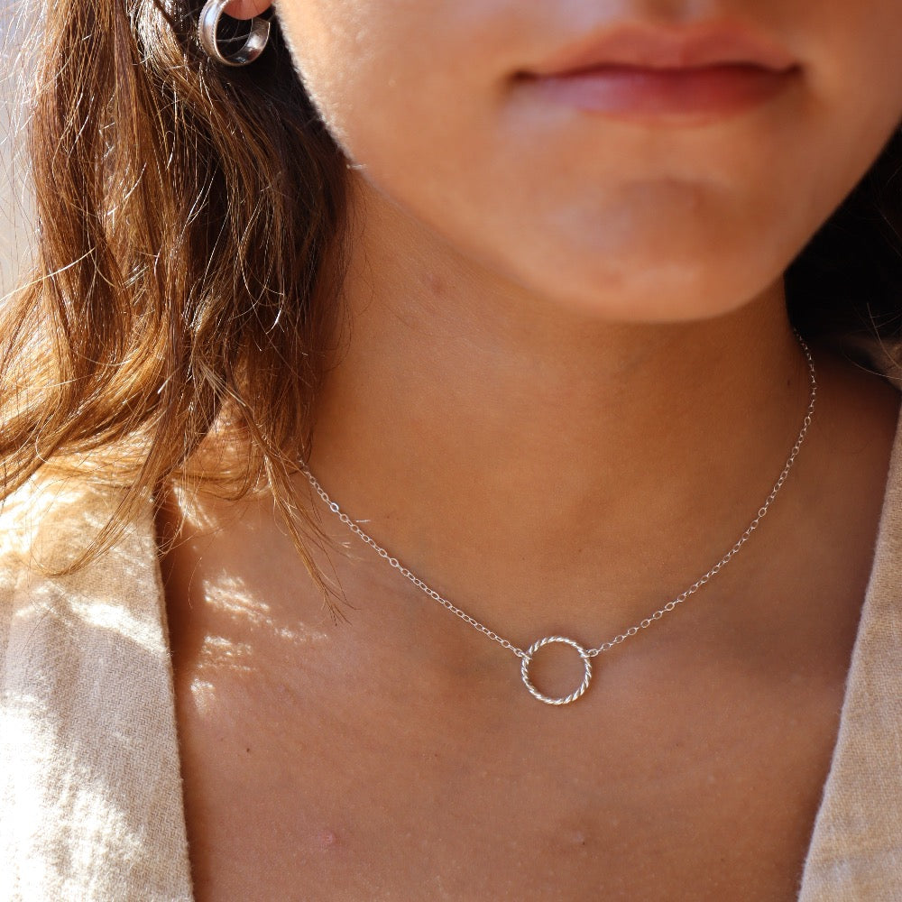 Model wearing 925 sterling silver Spiral Necklace. This necklace features the simple chain with the spiral eternity disc.