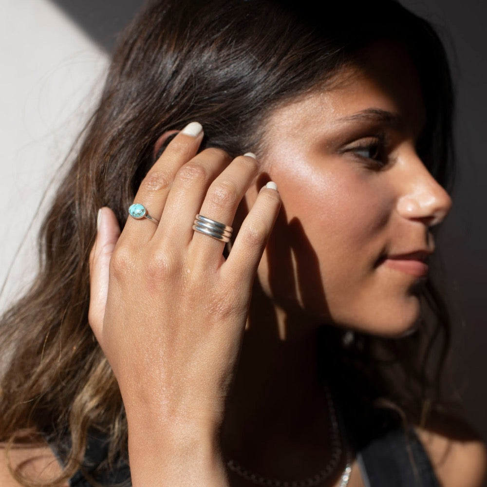 Sterling Silver turquoise gemstone ring photographed on a brunette model, handmade by Token Jewelry