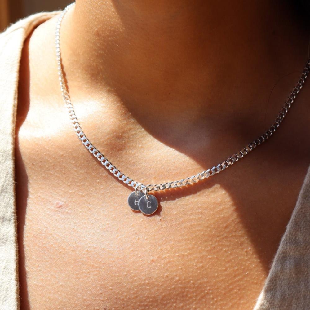 Model Wearing 925 sterling silver Modern Muse initial Necklace in sterling silver. This necklace feature the Carter chain with the choice of adding on an initial charm.