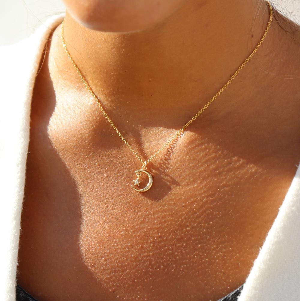 Model wearing Moon Star Charm Necklace in 14k gold fill 