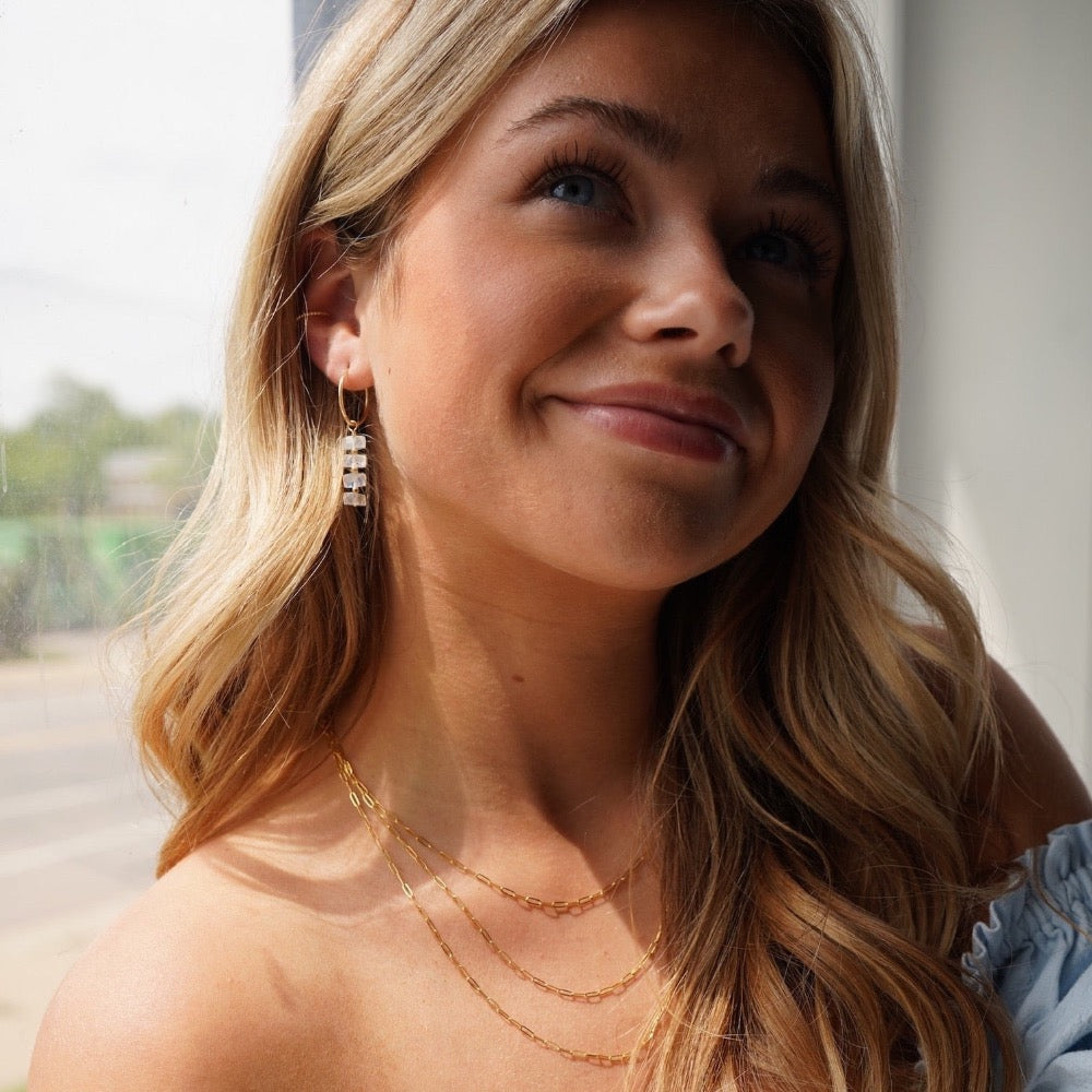 Model wearing 14k gold fill Selene Hoops, These Earrings feature our 16mm Goldie hoops along with 4 Moonstone Faceted gemstones stacked onto of each other