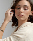 Model wearing 14k gold fill Square Hoops - Token Jewelry