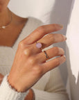 Model wearing our gold Pippa ring. This ring features a Pink Kunzite gemstone with a delicate spiral band. 