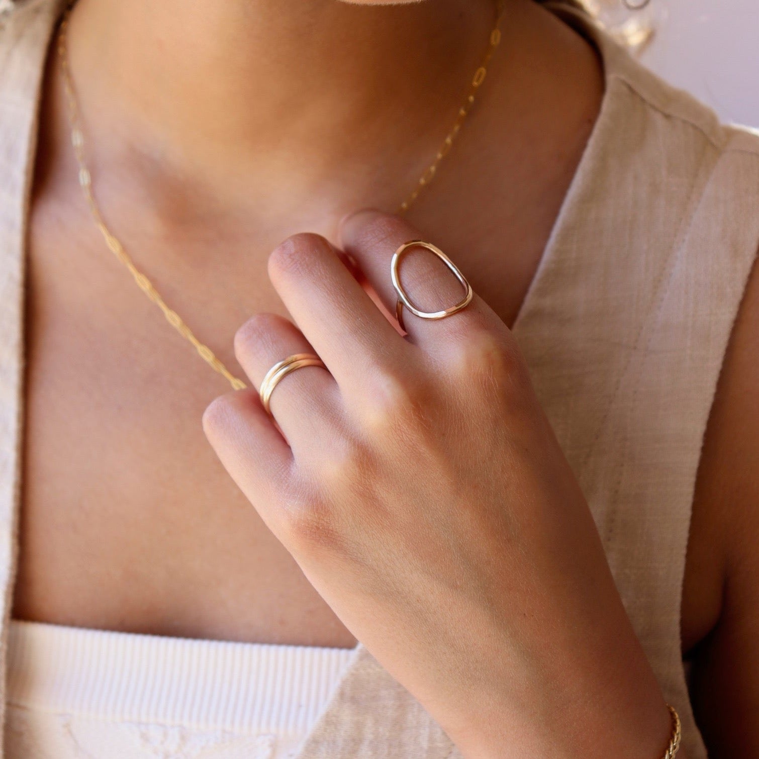 model wearing 14k gold fill circle ring.