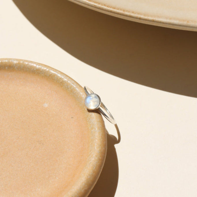 Close-up of stackable moonstone glow ring with iridescent shimmer in sterling silver