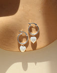 925 Sterling Silver Classic Hoops featuring a dainty Mother of Pearl heart-shaped charm on each 15mm hoop