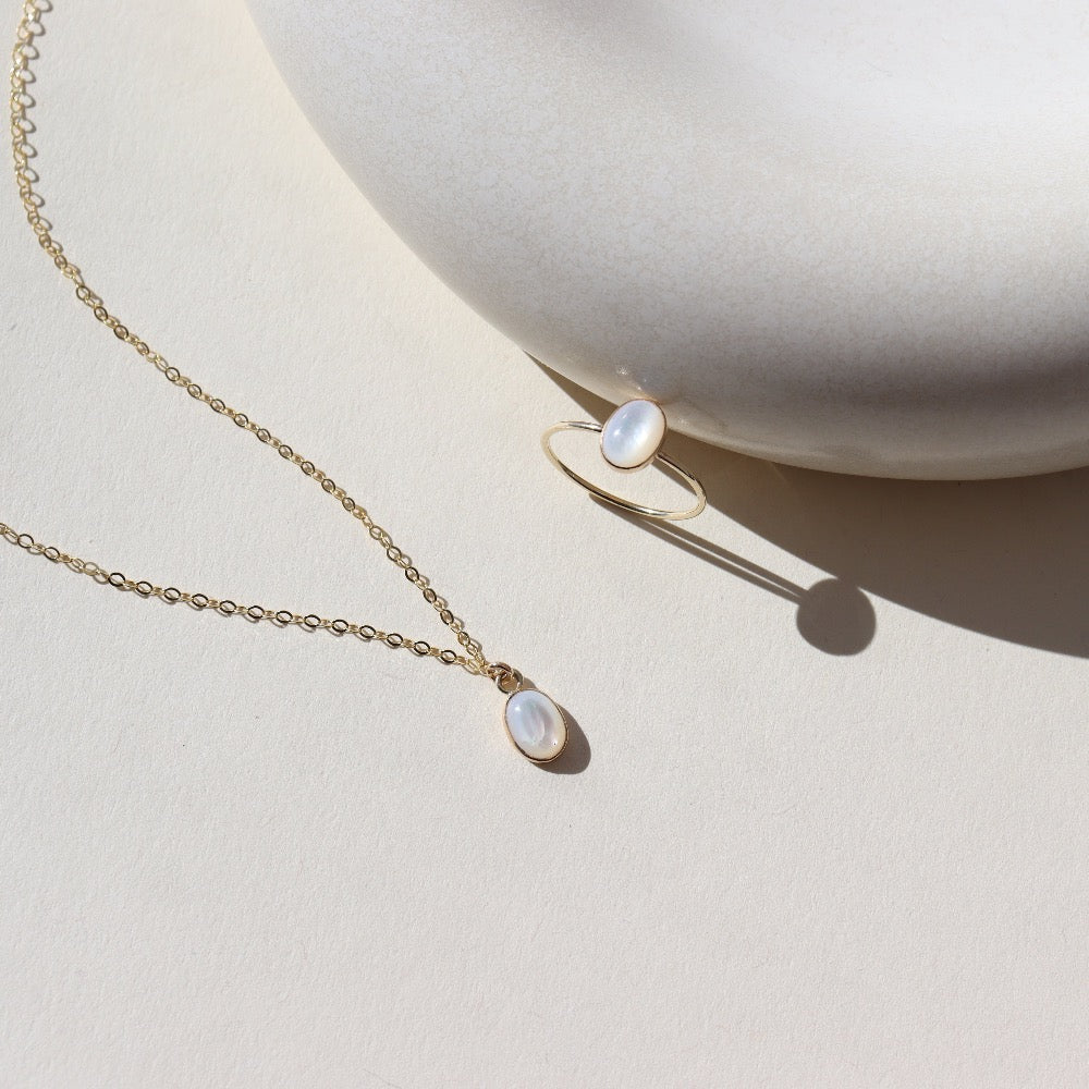 Mother of pearl ring called the Aurelia ring and Aurelia necklace