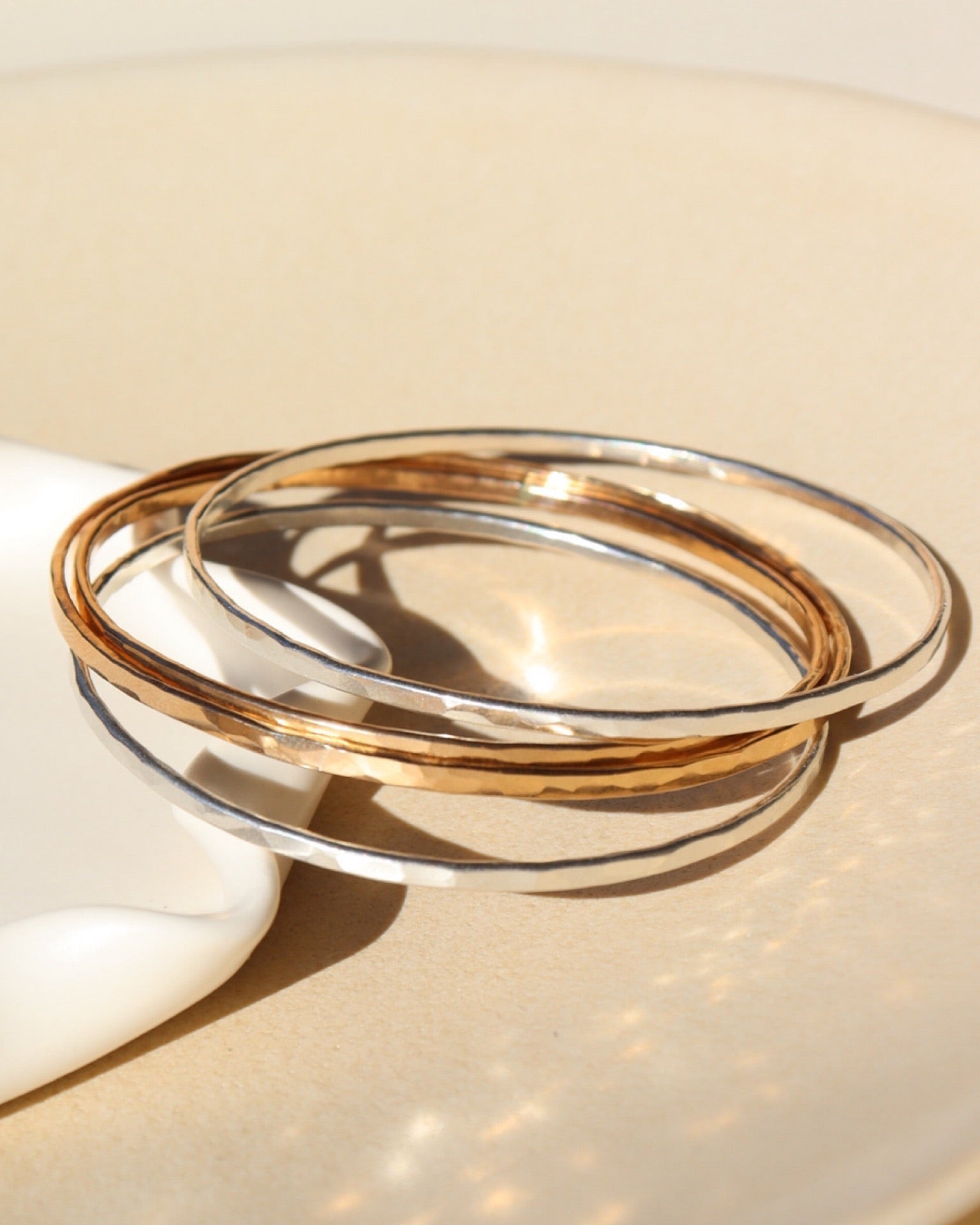 Multiple Hammered Bangles in 14k gold fill and sterling silver