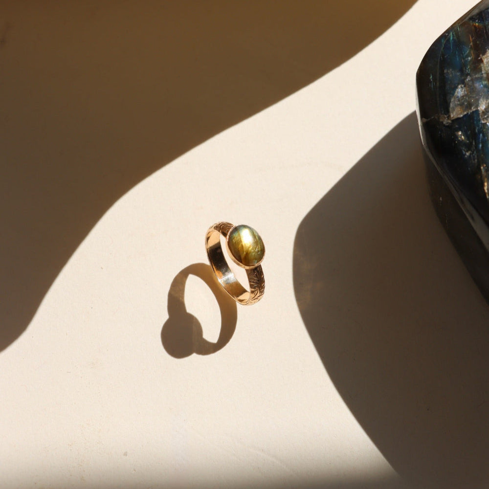 Textured gold floral band ring with bezel-set labradorite stone
