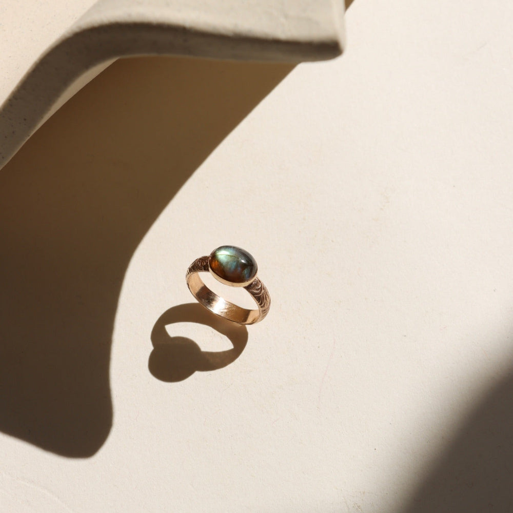 Textured gold floral band ring with bezel-set labradorite stone