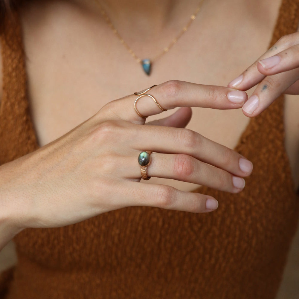 Textured gold floral band ring with bezel-set labradorite stone