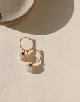 Gold hoop earrings featuring iridescent moonstone charms with soft, shimmering hues.
