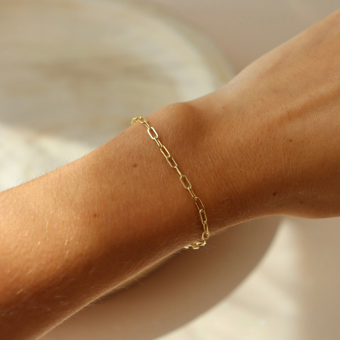 model wearing 14k gold fill paperclip chain bracelet