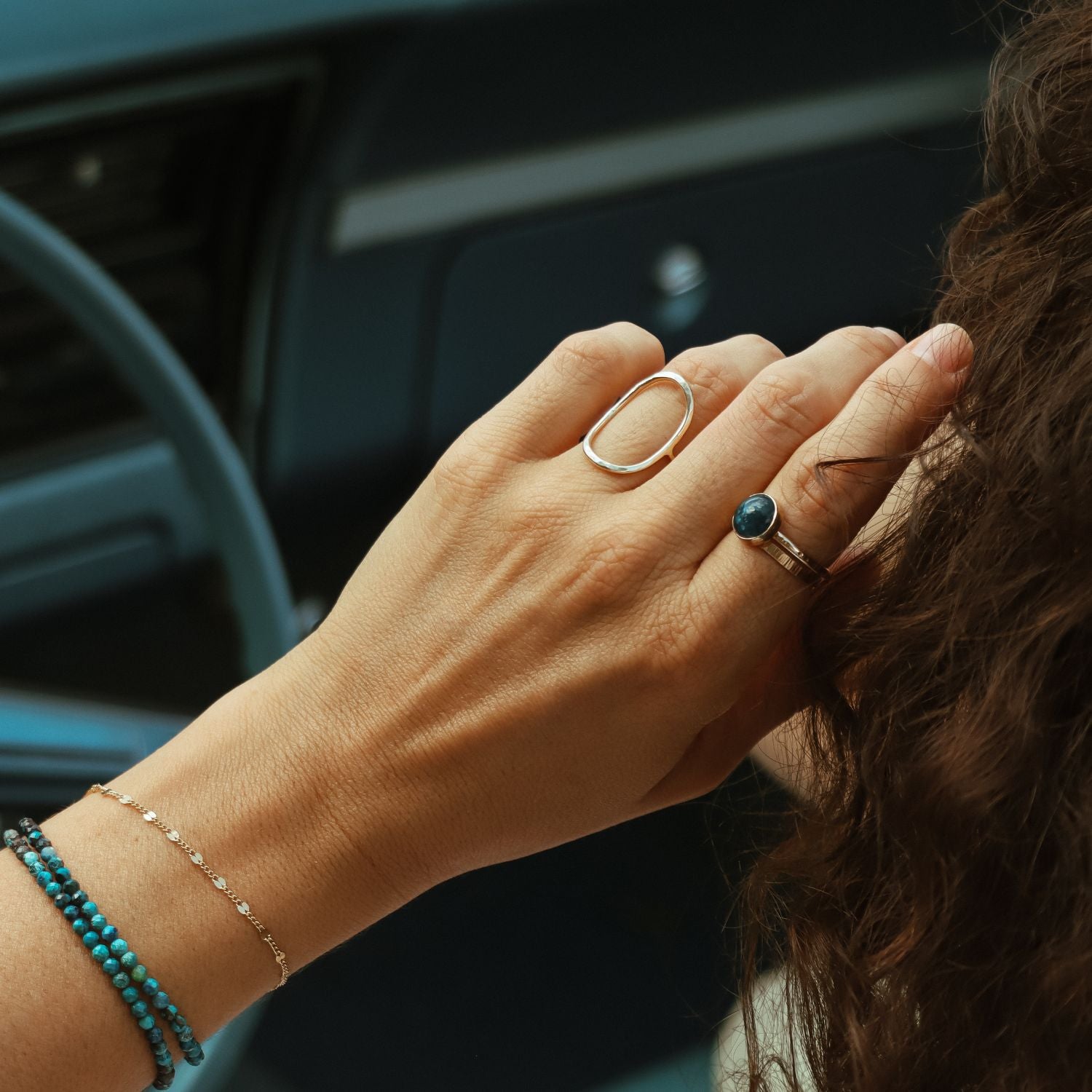 model wearing sterling silver jewelry with gemstone accents