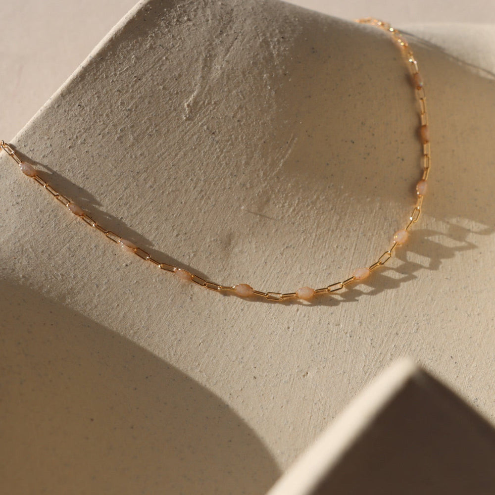 Opal Enamel chain links with 14k gold filled delicate paperclip chain on a light background.