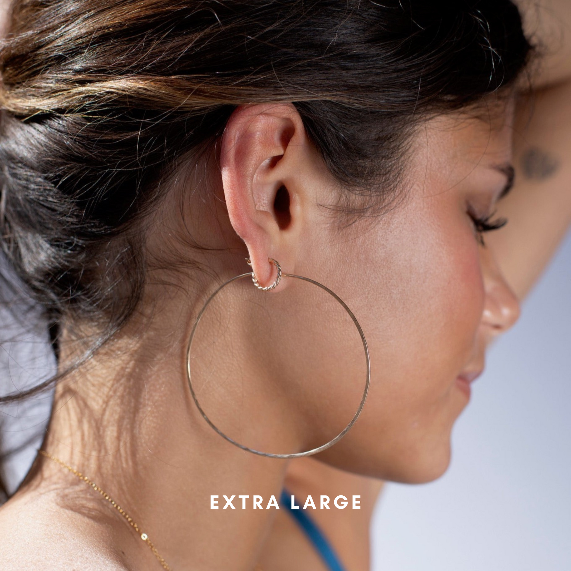 model wearing extra large 14 gold fill hammered hoop earrings with 14k gold fill spiral hoop earrings