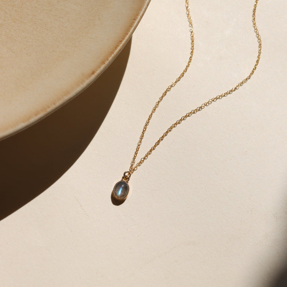 Minimal bezel-set labradorite pendant necklace on gold chain, handmade by Token Jewelry