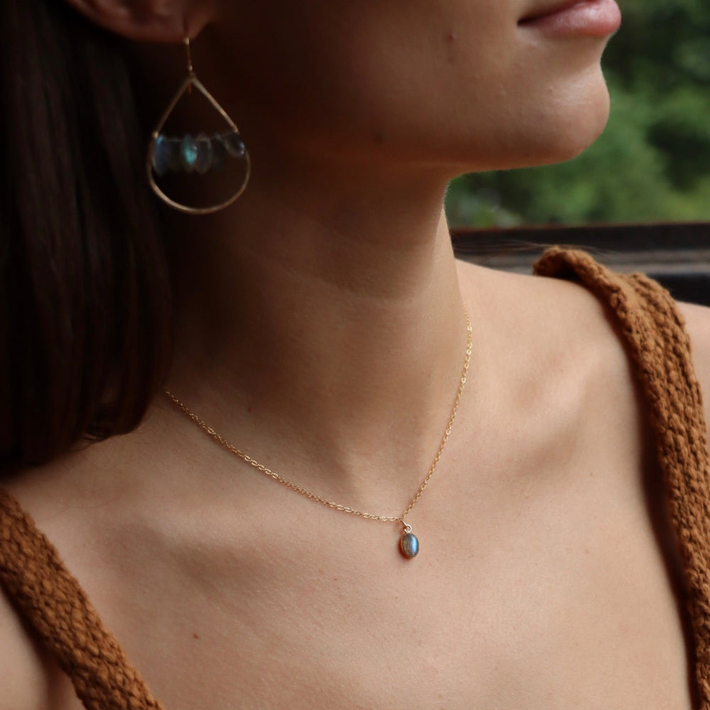 Minimal bezel-set labradorite pendant necklace on gold chain, handmade by Token Jewelry