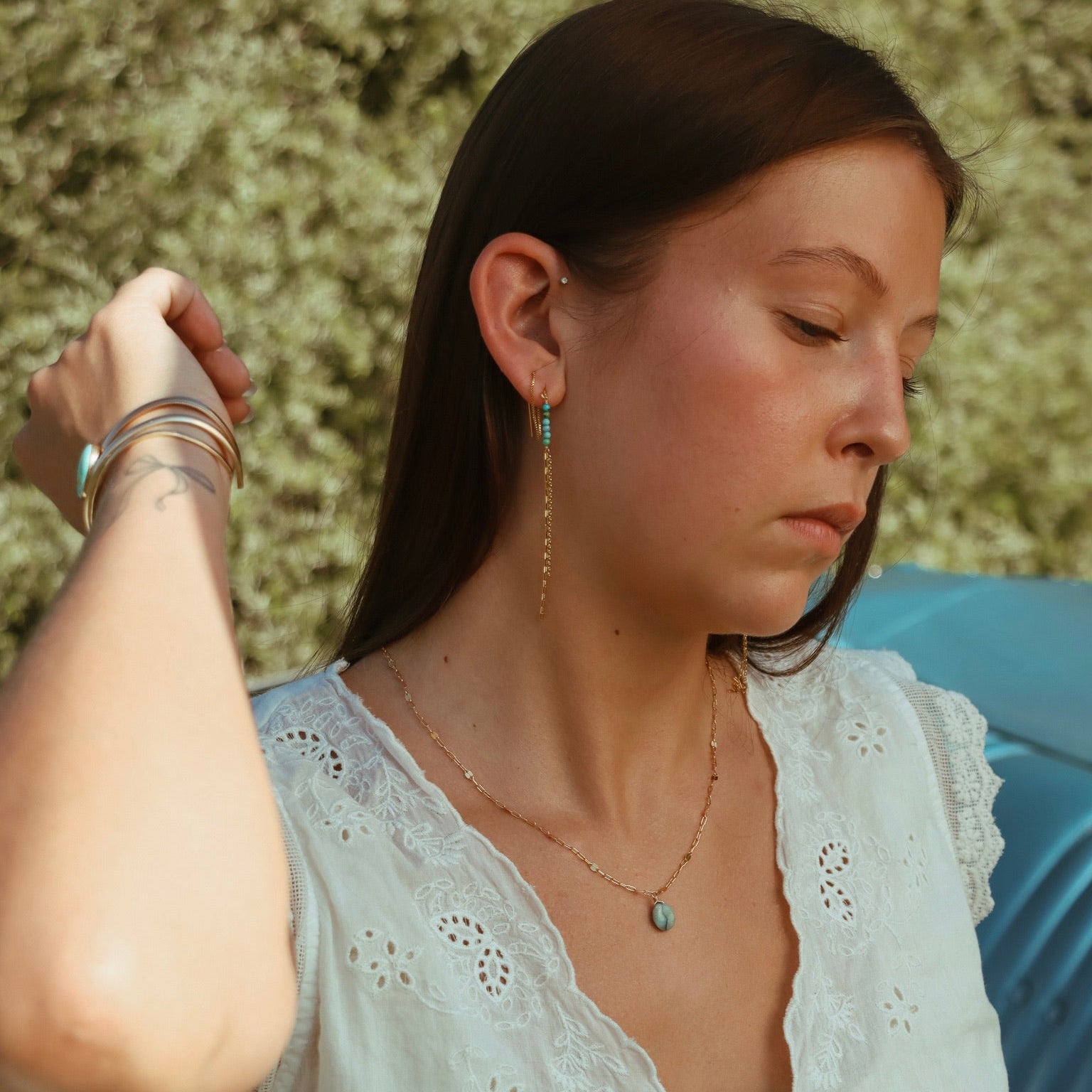 model wearing 14k gold fill jewelry with azurite and turquoise gemstones