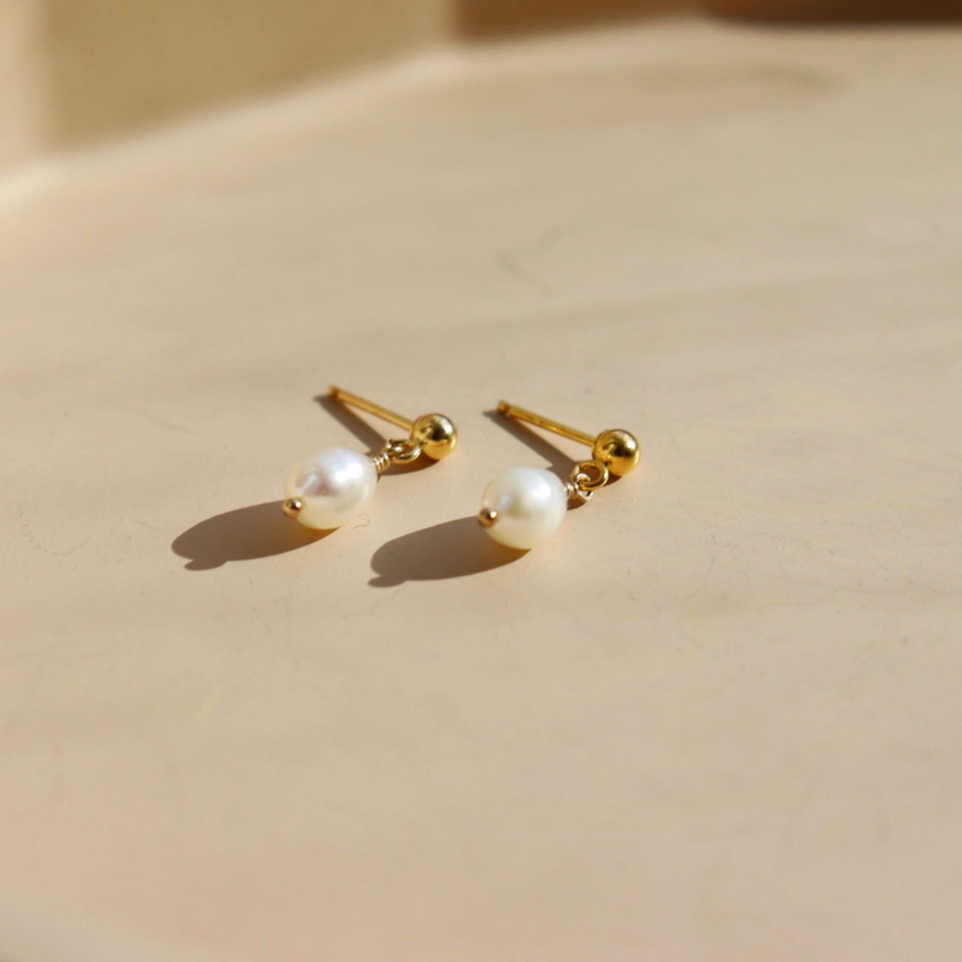 delicate handmade pearl drop stud earrings. made by Token Jewelry in Eau Claire, wisconsin