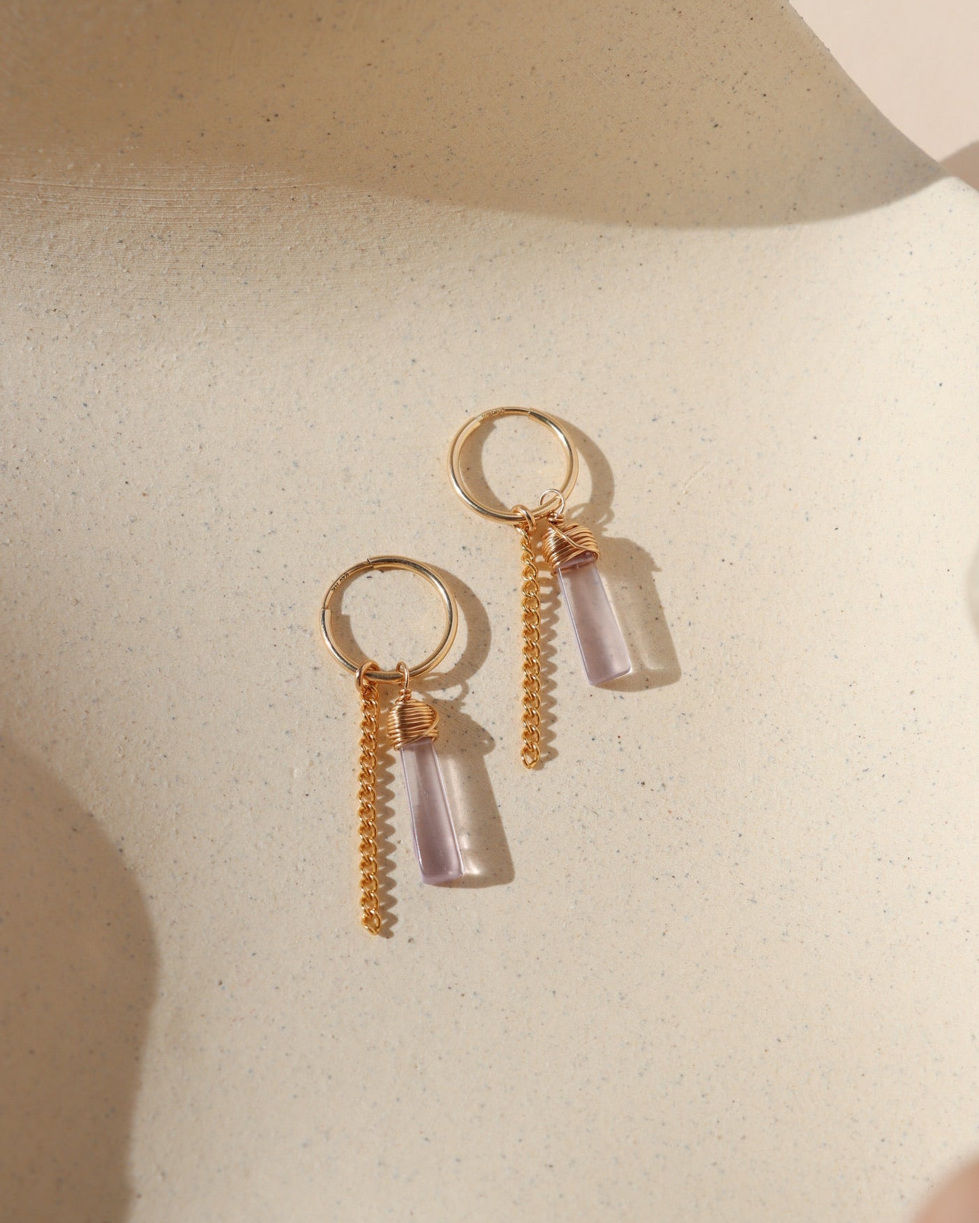 14k gold fill hoop earrings with pink amethyst charms and 14k gold fill chain on a light background