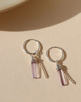 sterling silver hoop earrings with pink ametyst charms and sterling silver chain on a light background