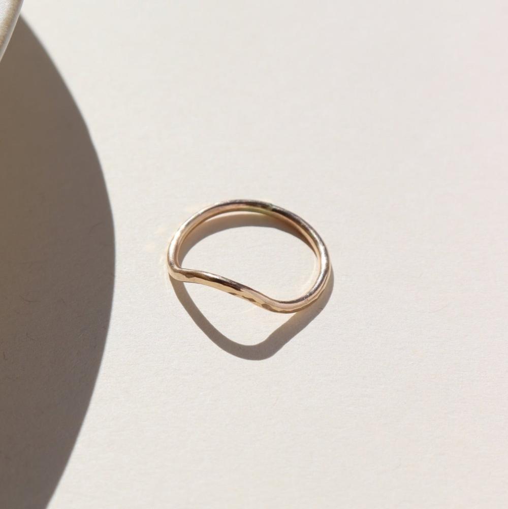 Plunge ring laid on a white plate in the sunlight